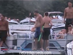 Home movie scene of a coed party at cove lake on spring break